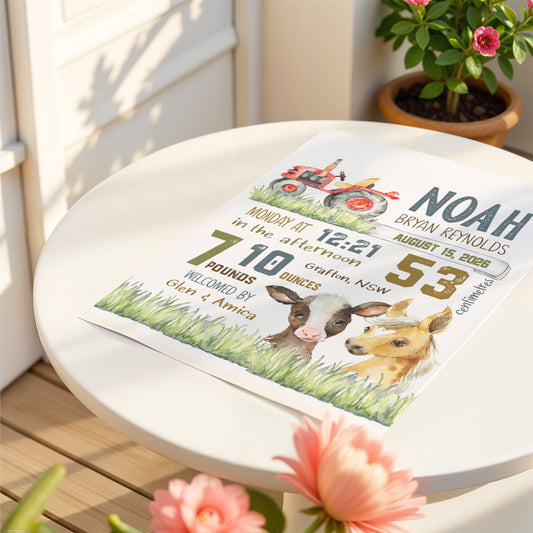 Newborn baby announcement card with farm animals on a table outdoors