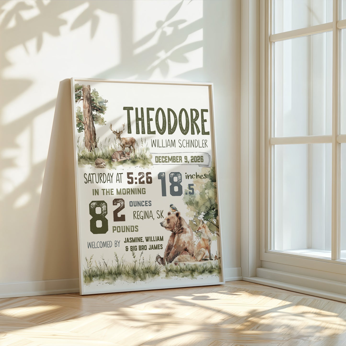 Personalized birth poster with bear design in a room with sunlight filtering through a window.